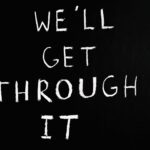 A motivational chalkboard message reading 'We'll get through it' on a black background.